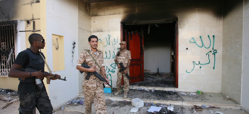 Libyan military guards check one of the U.S. Consulate's burnt out buildings in September 2012.