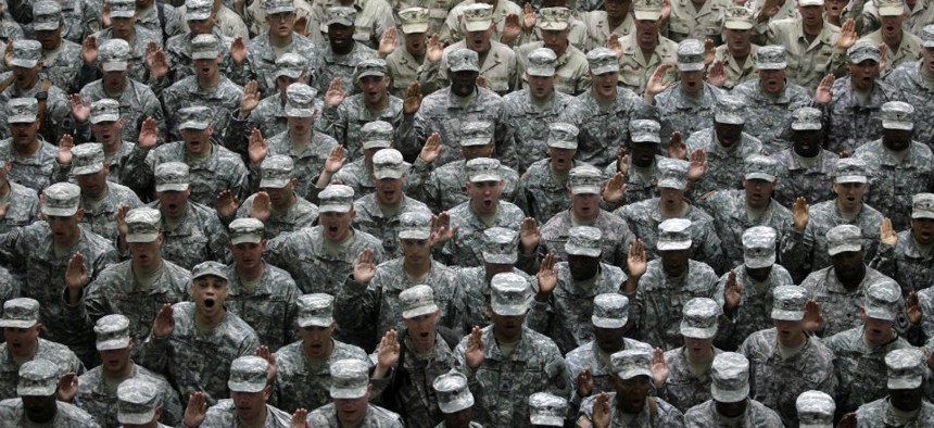 U.S. military service members take an oath at a mass re-enlistment ceremony in Baghdad, Iraq.