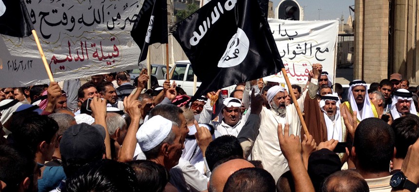 Demonstrators chant pro-ISIL slogans during a rally June 16 in Baghdad.