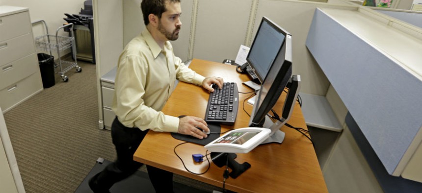 An employee works at a treadmill desk.