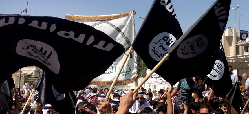Demonstrators wave ISIL flags during a Baghdad rally earlier this month.