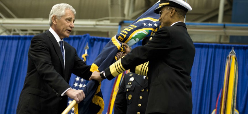 U.S. Defense Secretary Chuck Hagel passes the Strategic Command flag to Navy Adm. Cecil Haney during a change-of-command ceremony in 2013.