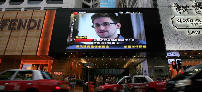Edward Snowden's face is shown on an outdoor screen in Hong Kong in 2013.