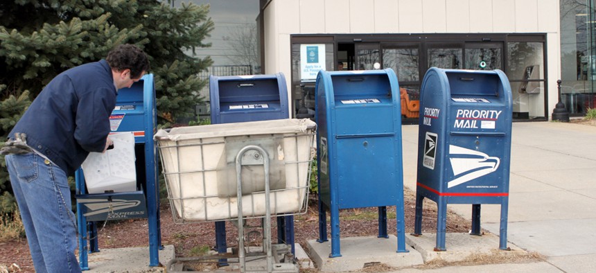 A postal worker in New Hampshire sorts mail in 2011.