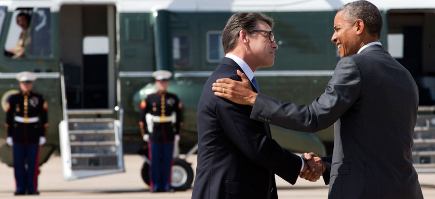 President Barack Obama, right, and Texas Gov. Rick Perry shake hands as Obama arrives in Dallas where they will attend a meeting about the border and immigration together.