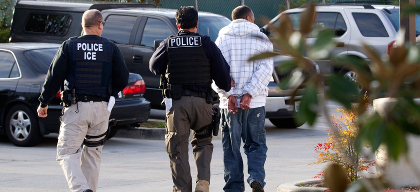 ICE agents take a suspect into custody in California in 2012.