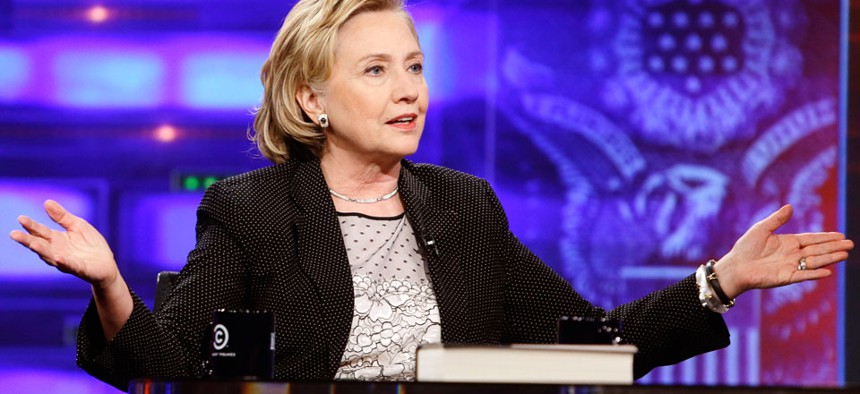 Former U.S. Secretary of State Hillary Rodham Clinton gestures while speaking to host Jon Stewart during a taping of "The Daily Show with Jon Stewart."