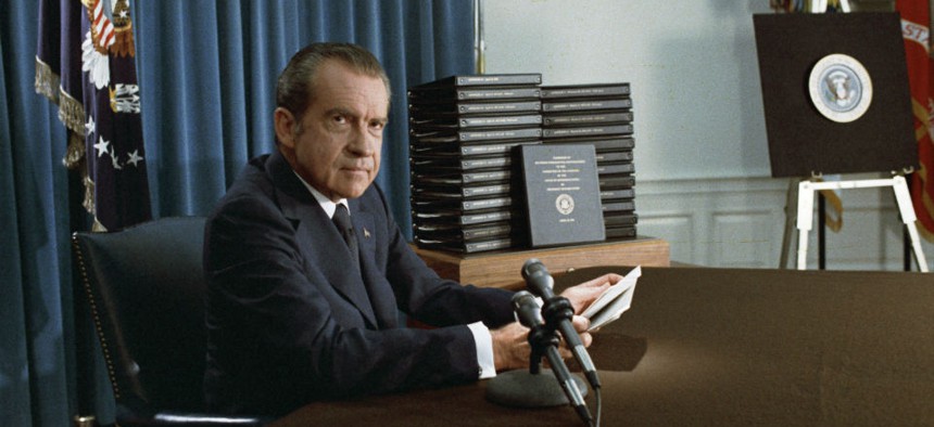 President Nixon, with edited transcripts of Nixon White House Tape conversations during broadcast of his address to the Nation in 1974.