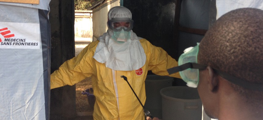 A doctor works in Guinea’s forest region during the Ebola outbreak in March.