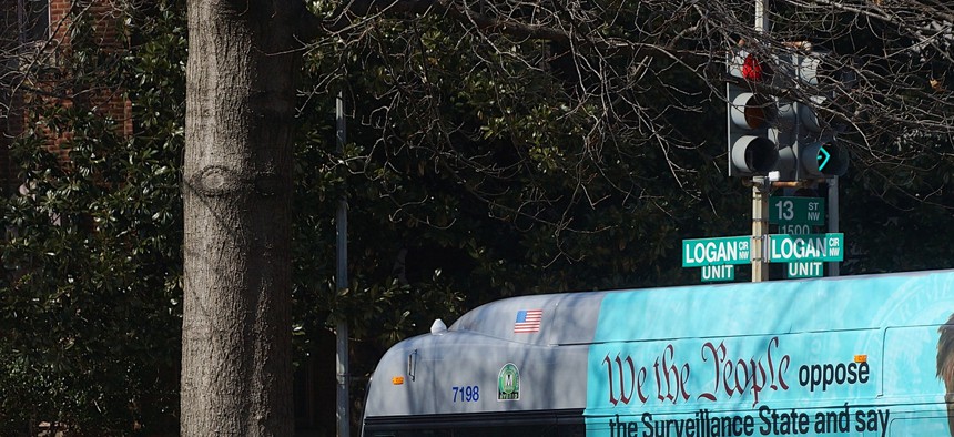A bus in DC is affixed with an ad supporting Edward Snowden in March.