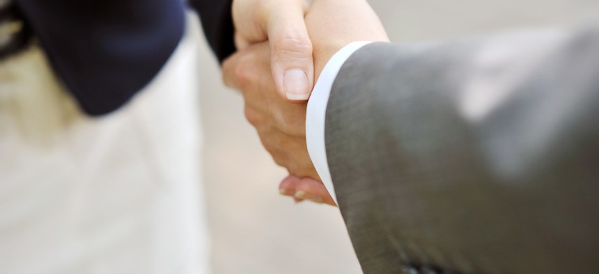 As far as touching, stick with the handshake in the office. 