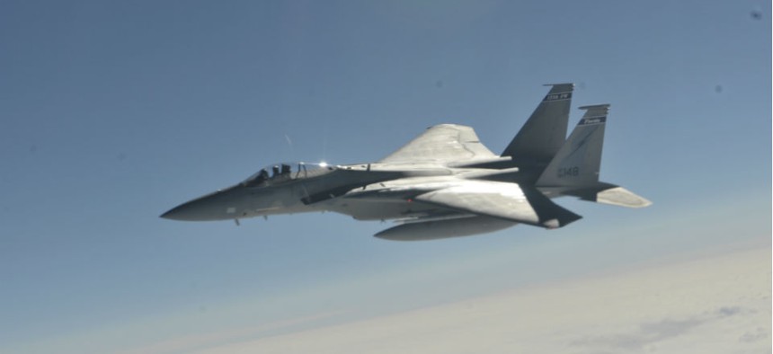 An F-15C fighter jet similar to the one that crashed awaits midair refueling. 