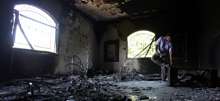 A Libyan man investigates the inside of the U.S. Consulate in Benghazi after it was attacked in September, 2012.