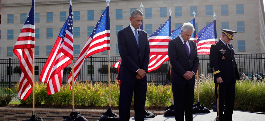 Barack Obama, Chuck Hagel and Martin Dempsey observe a moment of silence at the Pentagon Thursday.