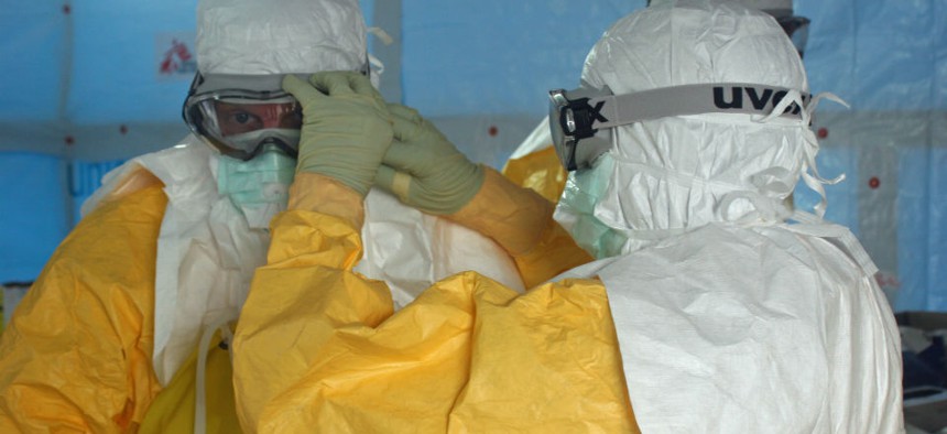 A CDC doctor prepares to enter an Ebola treatment center in Liberia. 