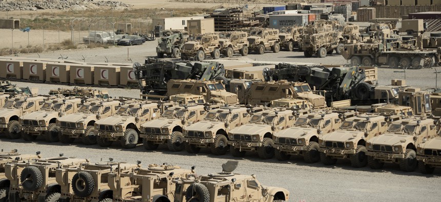 Military vehicles and accessory equipment sit in a retrograde yard at Bagram Airfield, Afghanistan before being shipped out of the country