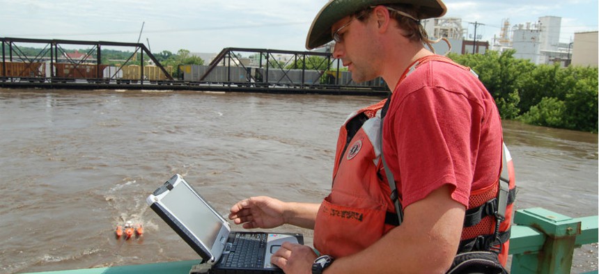 A U.S. Geological Survey employee monitors the Iowa River in Cedar Rapids during the 2008 flood. 