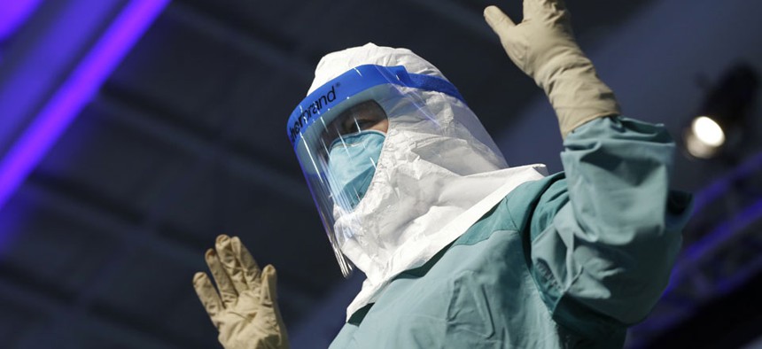 Nurse Barbara Smith demonstrates the proper way for health care workers to use personal protective equipment when dealing with Ebola during an education session in New York on Tuesday.