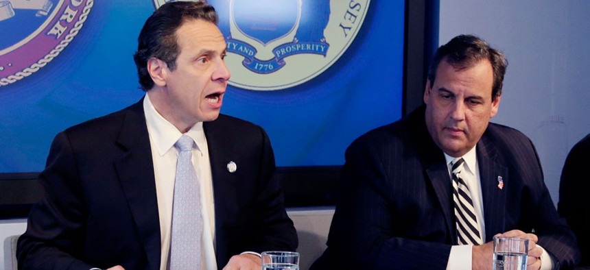 New York Governor Andrew Cuomo, left, speaks as New Jersey Governor Chris Christie listens at a news conference, Friday.