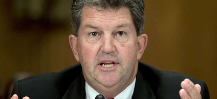 Postmaster General Patrick Donahoe defended USPS' decision to delay informing employees their personal data had been breached.