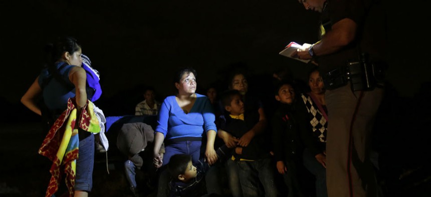 A group of immigrants from Honduras and El Salvador who crossed the U.S.-Mexico border illegally are stopped in June 2014, in Granjeno, Texas. 