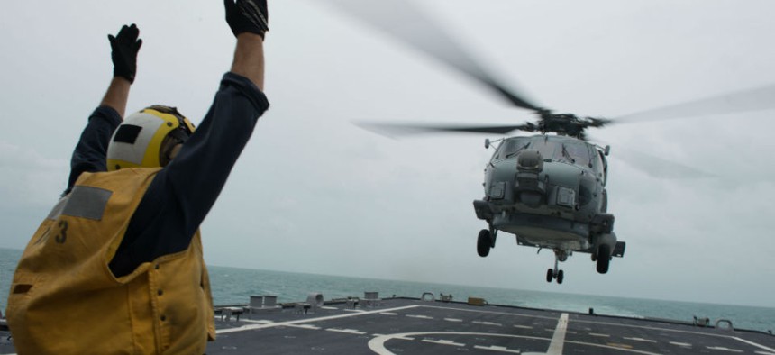 The USS Fort Worth conducts helicopter search and recovery operations as part of Indonesian-led efforts to locate the AirAsia plane that crashed last week. 