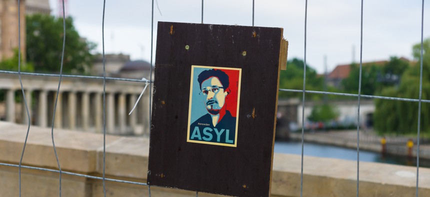 A sign supporting Edward Snowden sits on a bridge in Berlin.
