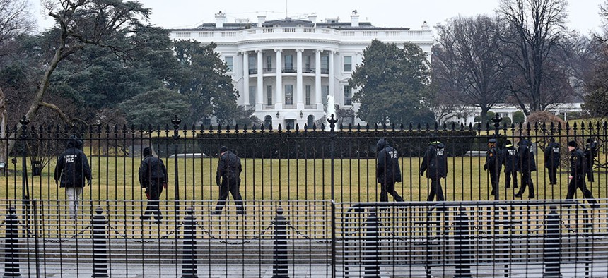 Secret Service officers search the grounds of the White House Monday.