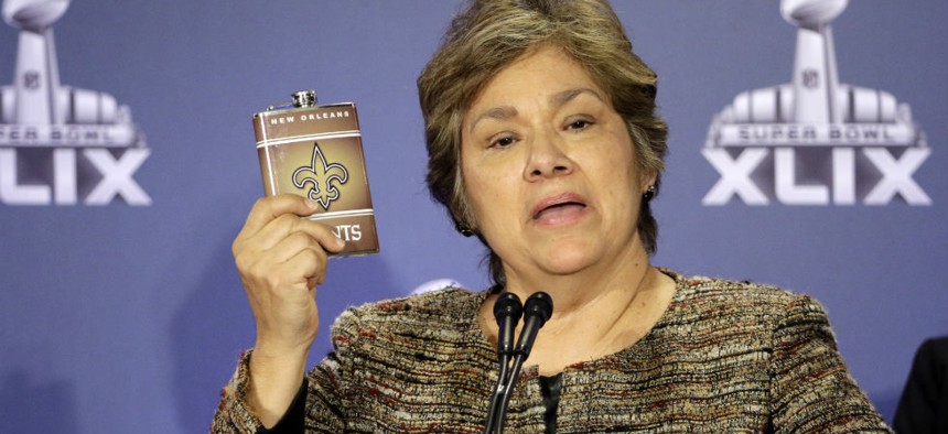 Sarah Saldaña holds up a counterfeit flask during a news conference Thursday in Phoenix.