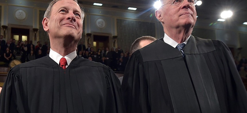 Chief Justice John G. Roberts and Supreme Court Justice Anthony M. Kennedy stand before President Barack Obama's State Of The Union address in January.