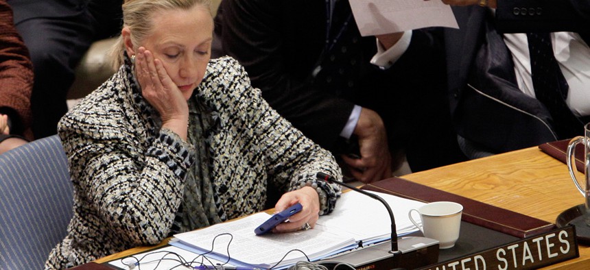 Hillary Clinton checks her phone during a United Nations session in 2012.