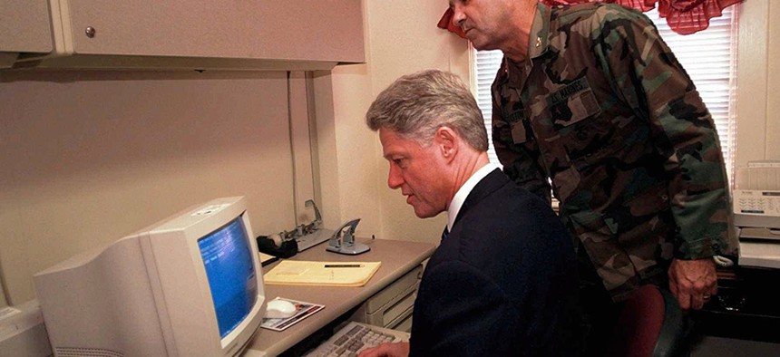 Col. Dan Houston shows President Clinton how to use a computer to send an e-mail to the troops at Camp Lejeune in 1996.