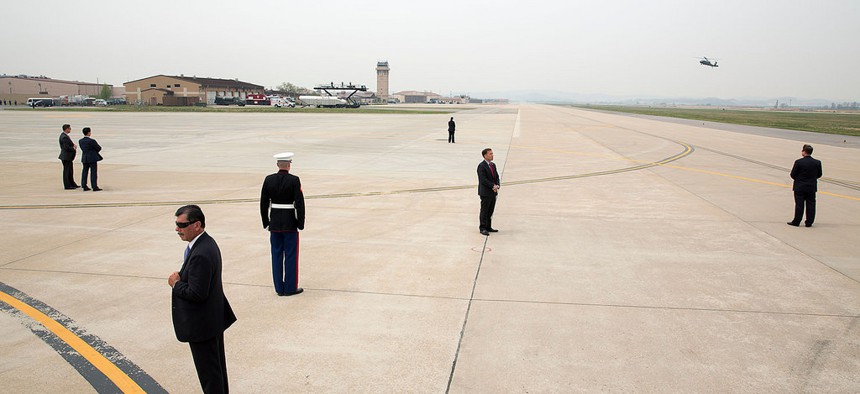 U.S. Secret Service agents are positioned on the tarmac as President Barack Obama arrives aboard Marine One in South Korea last year.