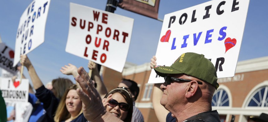 Pro-police demonstrators stand outside the Ferguson, Mo., police department last weekend. 
