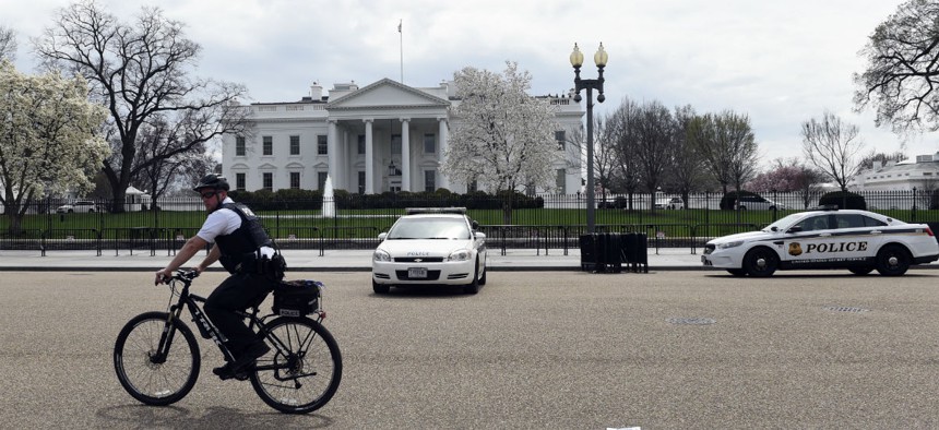 A Secret Service agent rides his bike by the White House on April 7 during widespread power outages across Washington.