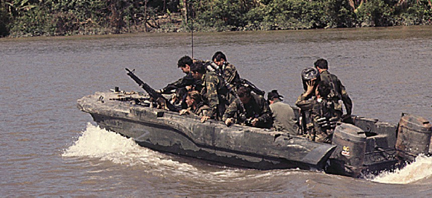 Members of U.S. Navy SEAL Team One move down Bassac River in a SEAL Team assault boat, November 19, 1967.