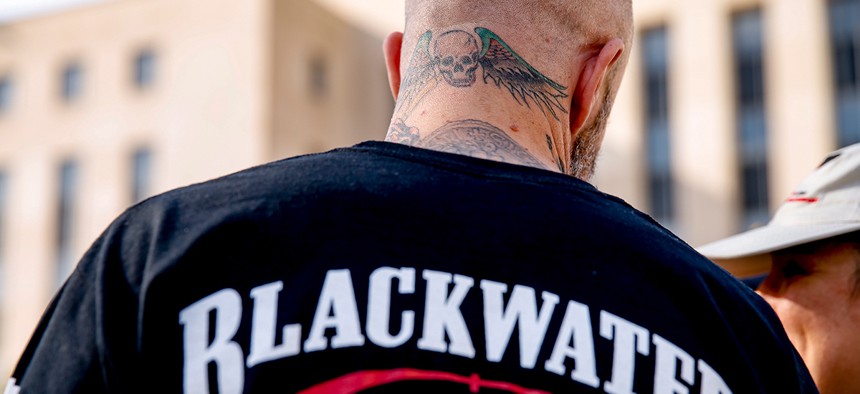 A former member of Blackwater joines family members, friends, and supporters of four former Blackwater security guards outside the federal court Monday.
