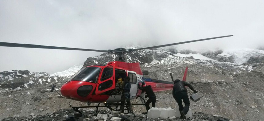 A rescue chopper lands carrying people from higher camps to Everest Base Camp, Nepal, Monday after the weekend earthquake.