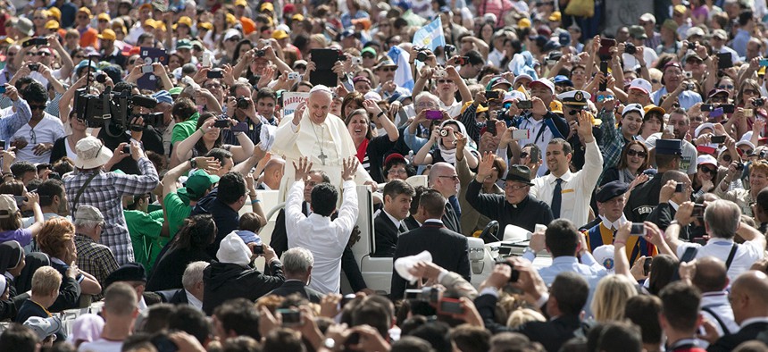 Pope Francis greets pilgrims in Vatican City in 2014.