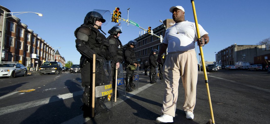 Victor Huntley-el thanks law enforcement officers as they stand guard Tuesday in Baltimore, in the aftermath of rioting.