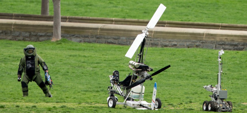 A member of a bomb squad approaches the gyrocopter after it landed in April.
