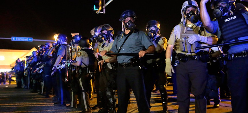 Ferguson police distribute riot gear in August. 