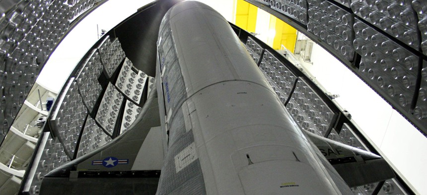 The X-37B, tucked inside the aerodynamic shell that will protect it on its way to space. 
