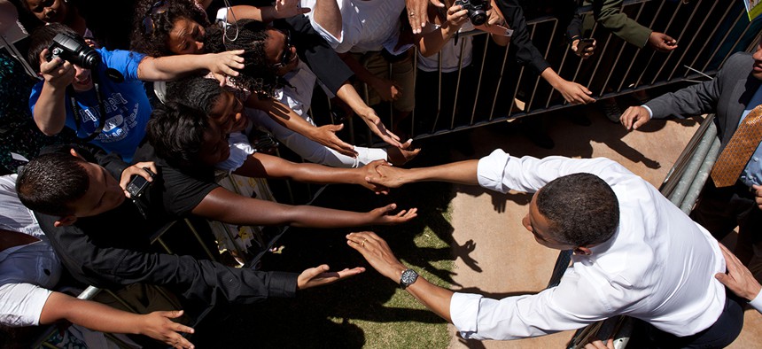 Obama shakes hands after speaking on immigration in El Paso in 2011.