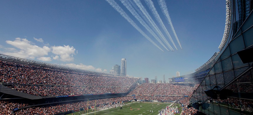 Military planes participate in a flyover at Soldier Field in September.