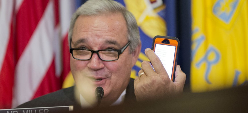 In February, House Veterans' Affairs Committee Chairman Rep. Jeff Miller, R-Fla., conveys a message from his mobile phone to VA Secretary Robert McDonald, a witness.