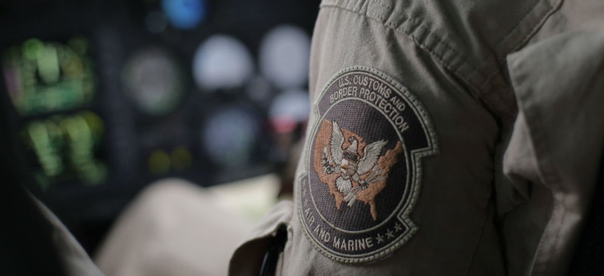 A U.S. Customs and Border Protection Air and Marine agent's patch is seen as he patrols patrol near the Texas-Mexico border in February.
