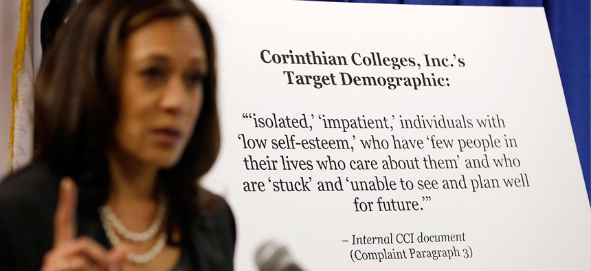 California Attorney General Kamala Harris gestures while standing by a display showing an internal document showing the target demographic of Corinthian Colleges in 2013.