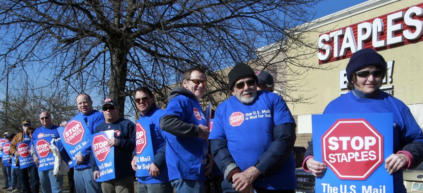 Postal workers protest outside a Staples in New Hampshire in April 2014. 