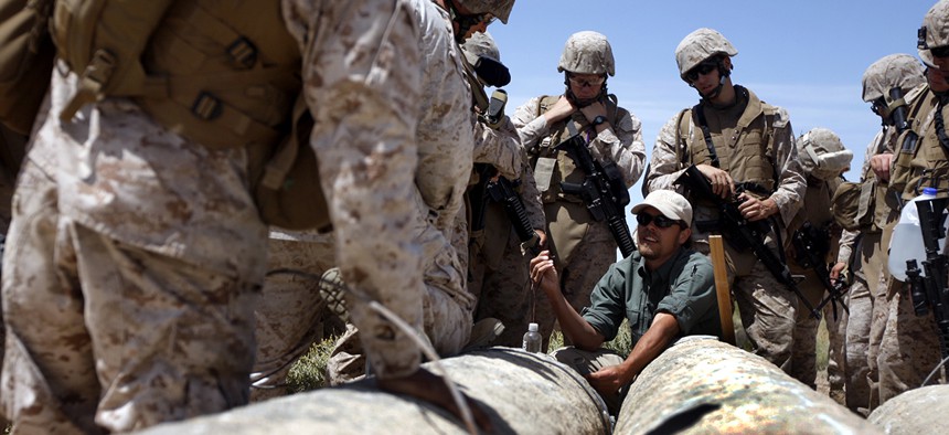 A counter improvised explosive device warfare instructor at Combat Center Range 800, gives instruction to Marines in 2013 during a training exercise.